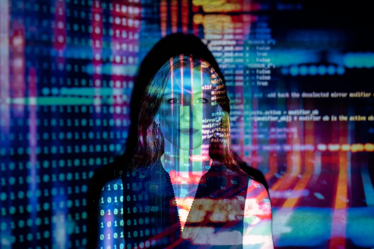 A person's hand interacting with a futuristic, high-tech user interface with glowing data visualizations.